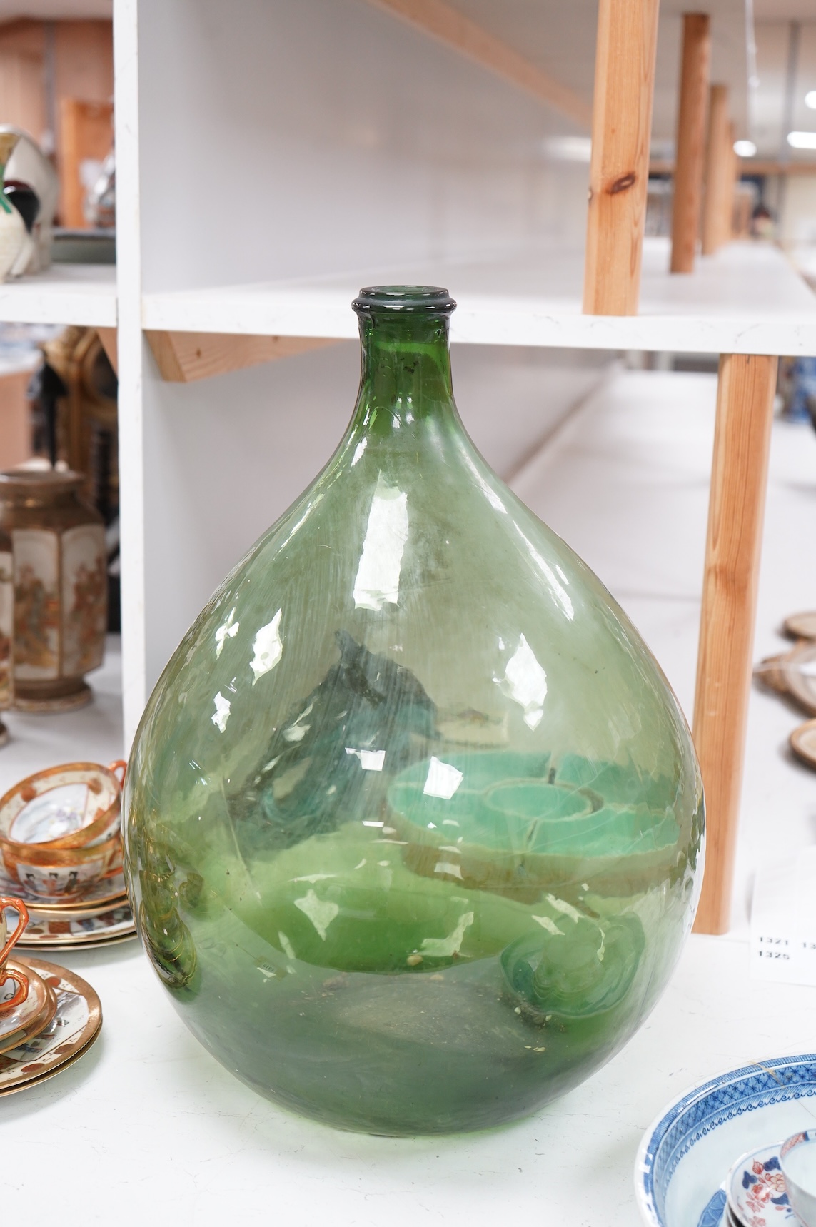 A large green glass carboy 51cm high